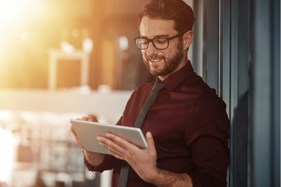 a man working at a fintech recruitment company looking at an ipad