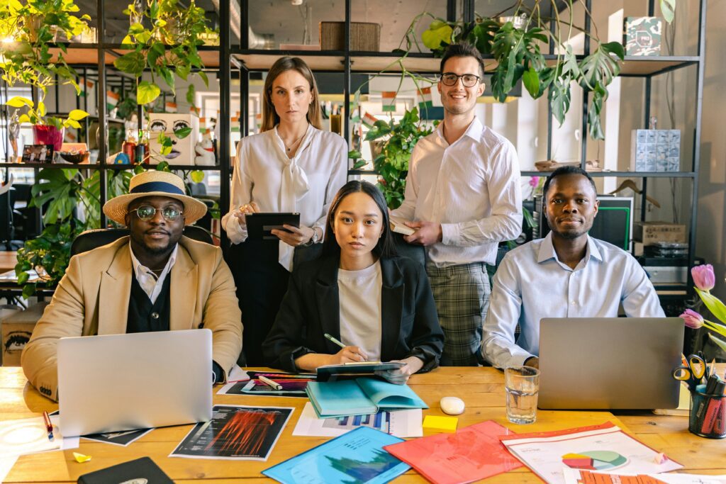 A group of people who work at EC1 Partners gathered around a desk talking about fintech