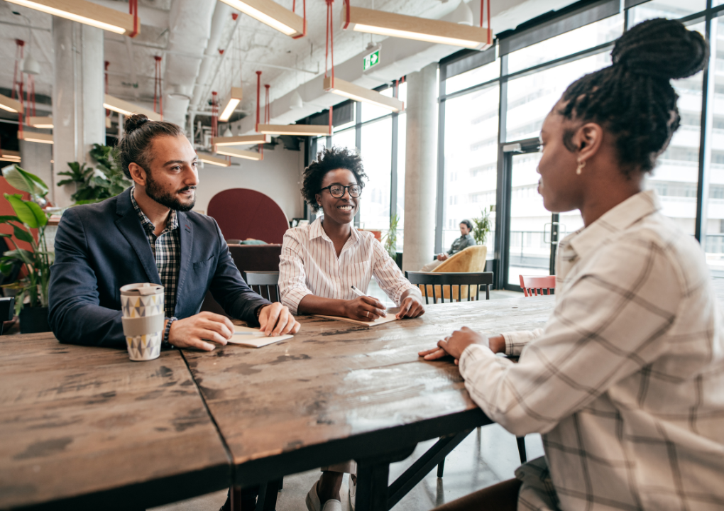 An image of two individuals discussing the benefits of hiring contractors in the fintech industry.